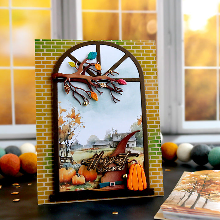Autumn-themed decorative item with pumpkins and 'Harvest Blessings' text on a brick-patterned stand.